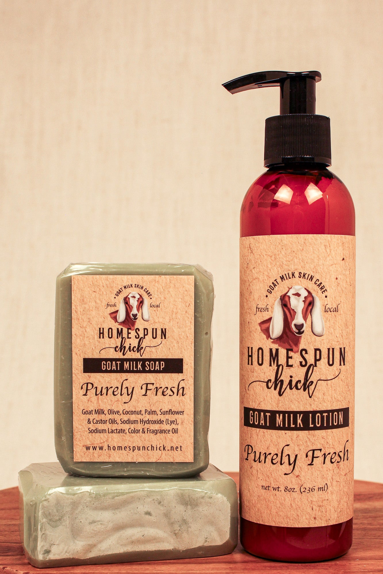 Homespun Chick goat milk soap and lotion on a wooden surface with a beige background