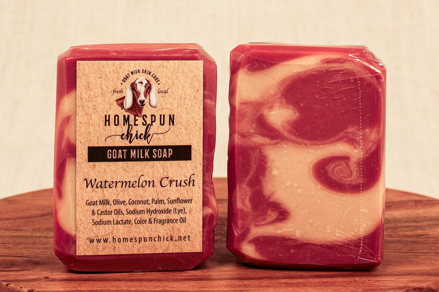 Two bars of soap with a visible label on a wooden surface