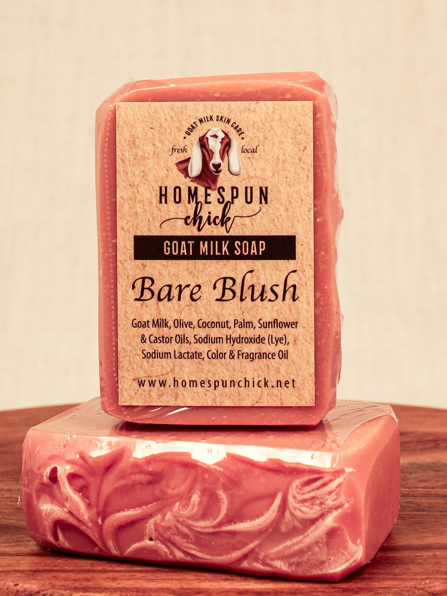 Bar of goat milk soap with a visible label on a wooden surface