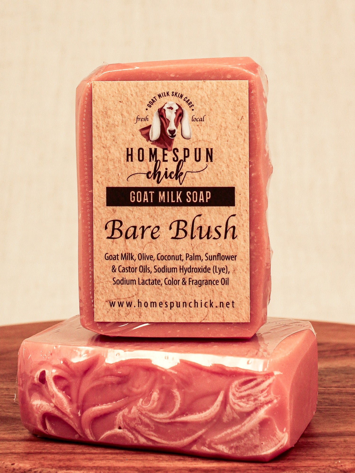 Bar of goat milk soap with a visible label on a wooden surface