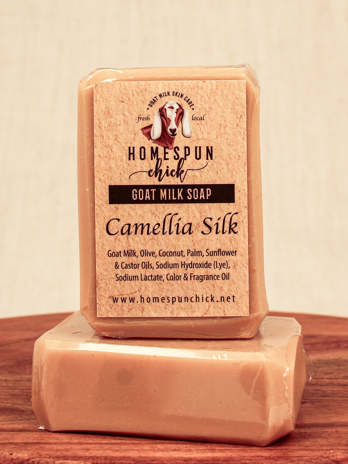 Bar of goat milk soap with 'Homespun Chick' branding on a wooden surface.