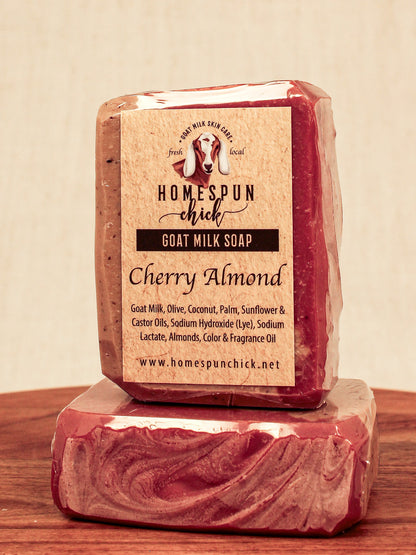 Goat milk soap bar with 'Homespun Chick' label on a wooden surface