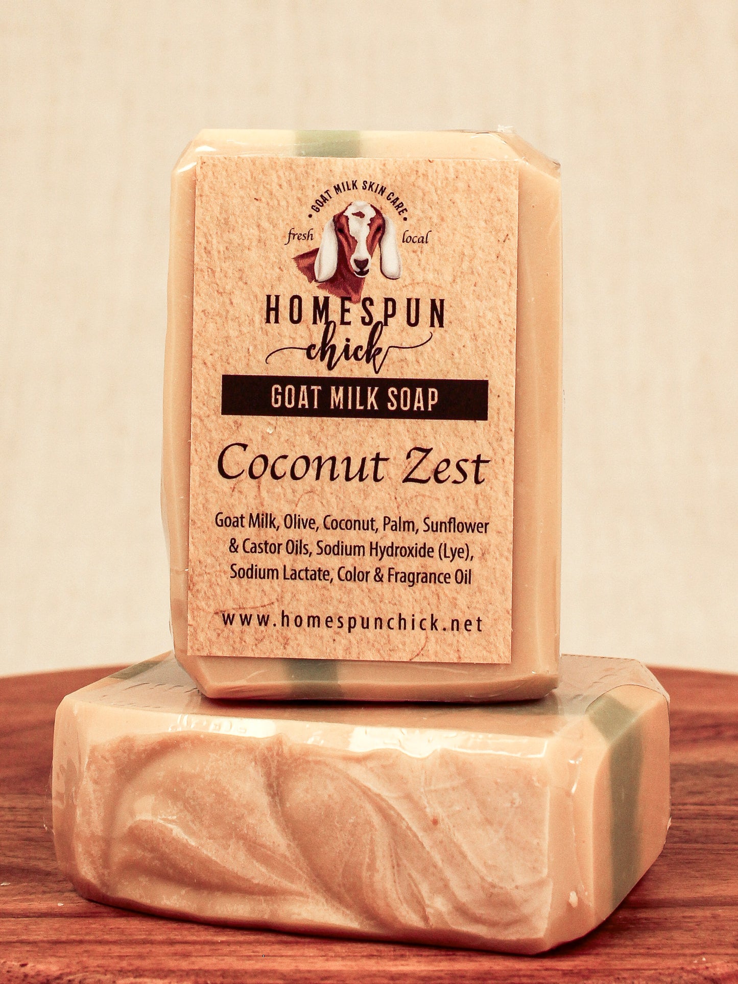 Bar of goat milk soap with 'Homespun Chick' branding on a wooden surface.