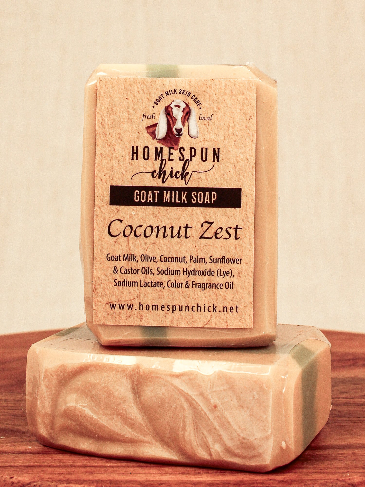 Bar of goat milk soap with 'Homespun Chick' branding on a wooden surface.