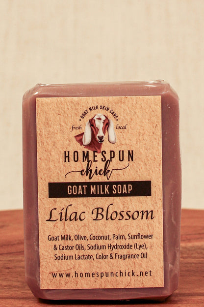 Bar of goat milk soap with 'Homespun Chick' label on a wooden surface