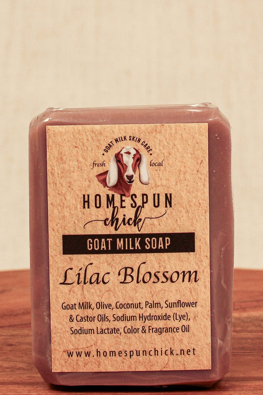 Bar of goat milk soap with 'Homespun Chick' label on a wooden surface