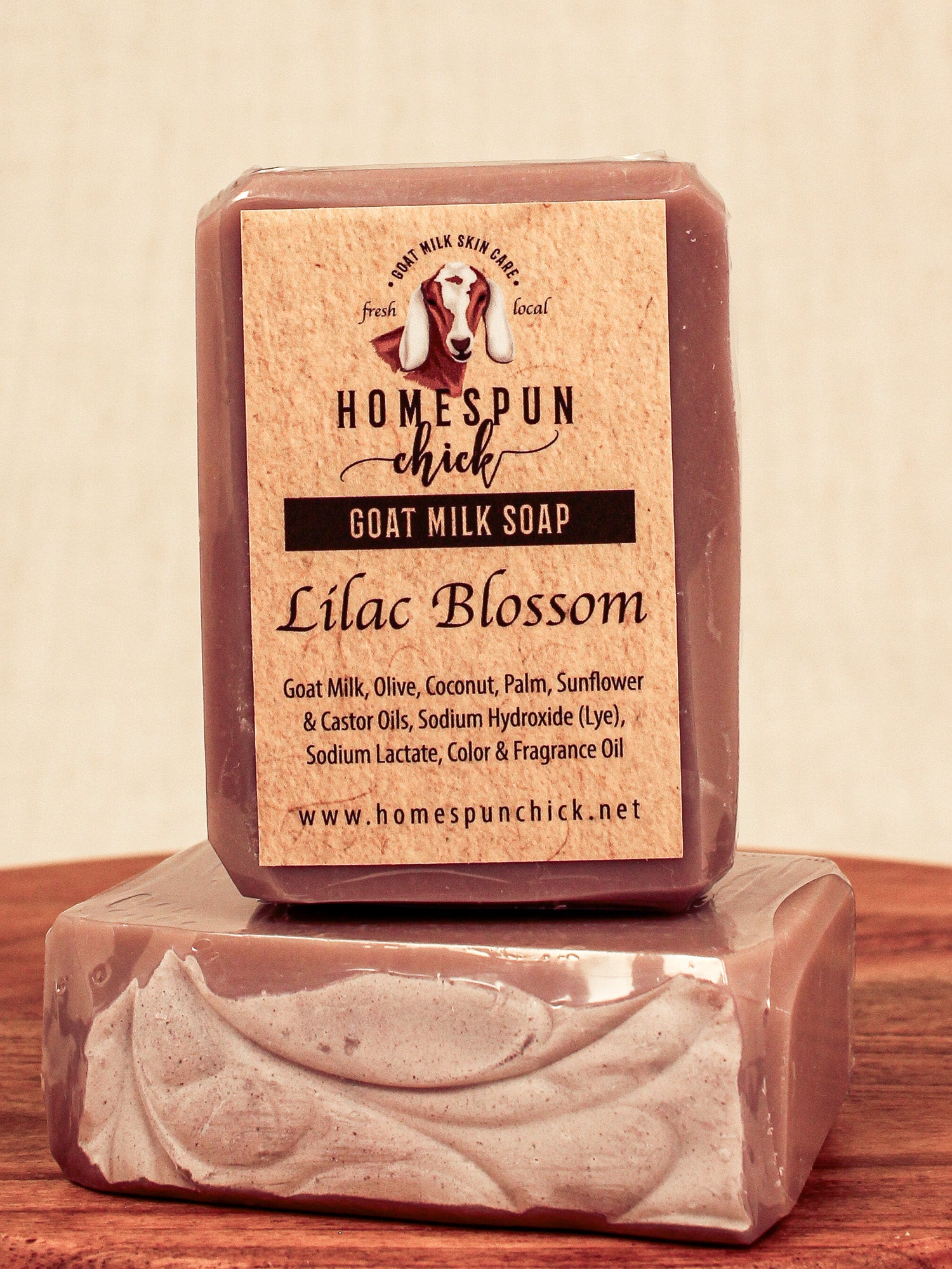 Bar of goat milk soap with 'Homespun Chick' label on a wooden surface