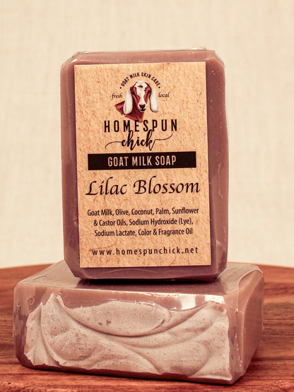 Bar of goat milk soap with 'Homespun Chick' label on a wooden surface