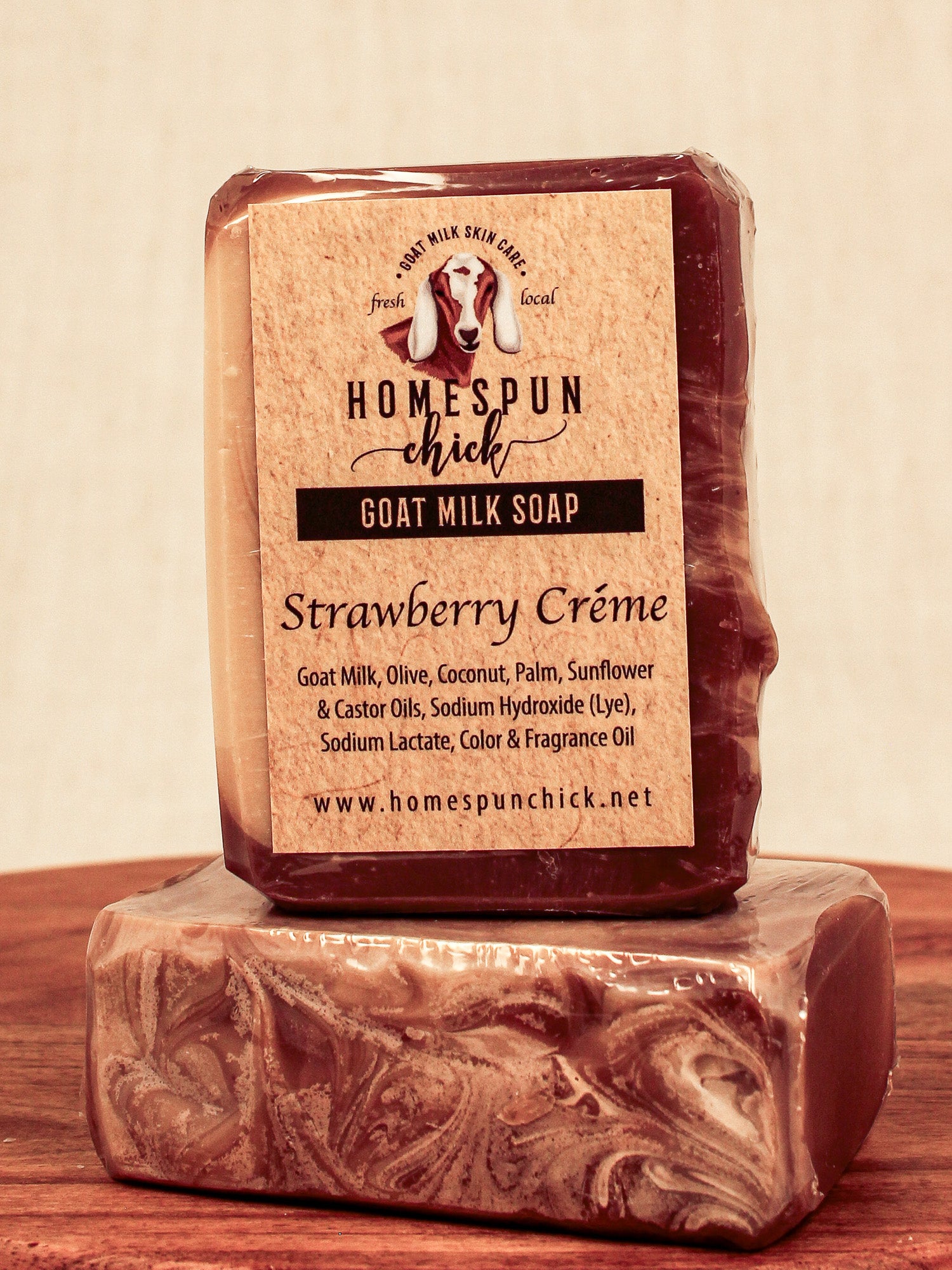 Bar of goat milk soap with 'Homespun Chick' label on a wooden surface