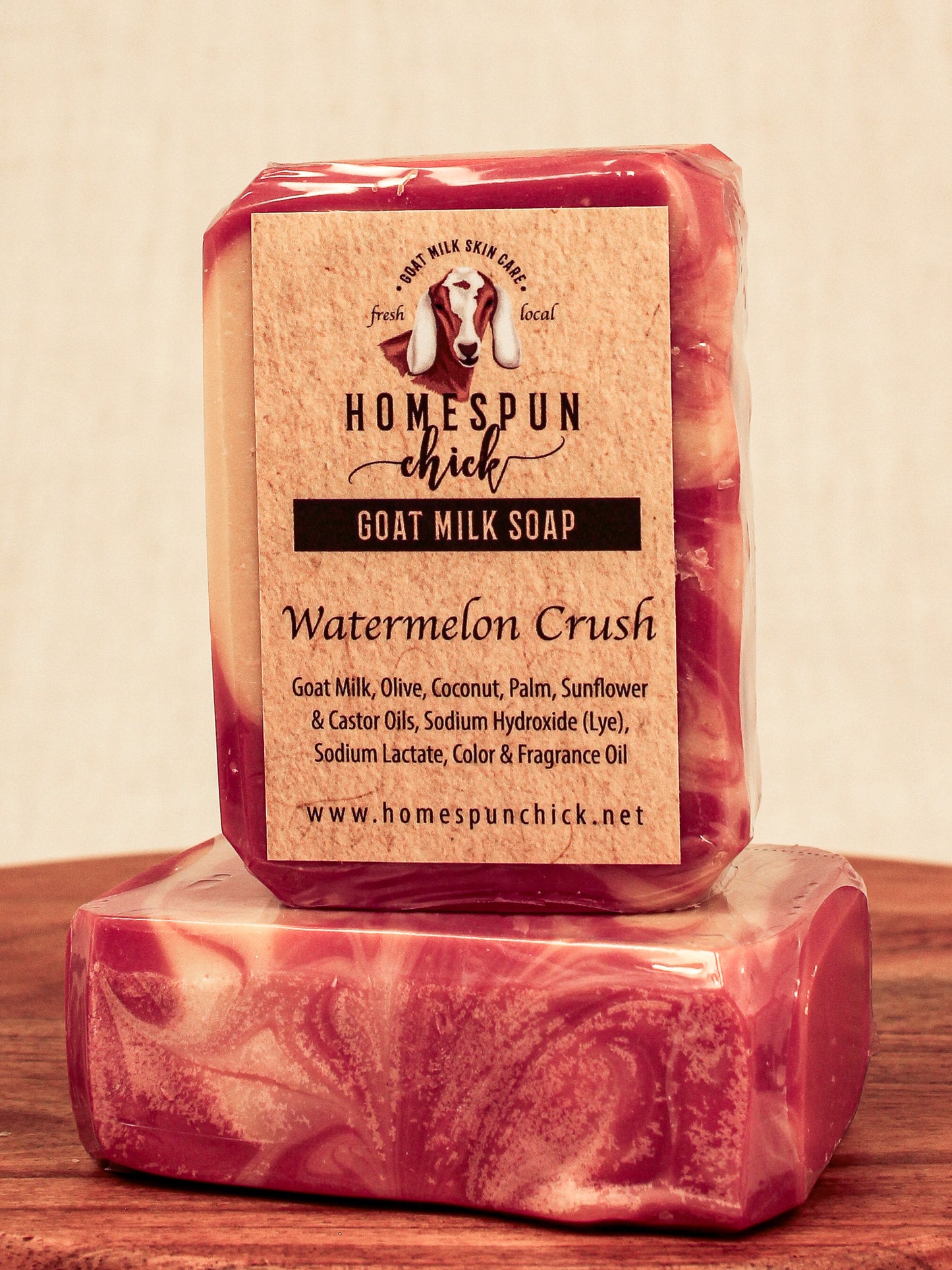 Bar of goat milk soap with 'Homespun Chick' label on a wooden surface