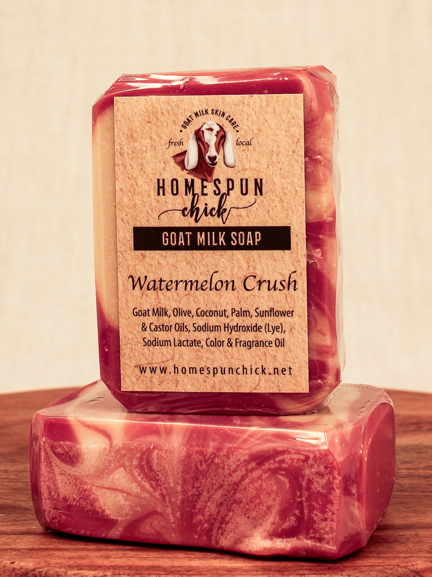 Bar of goat milk soap with 'Homespun Chick' label on a wooden surface