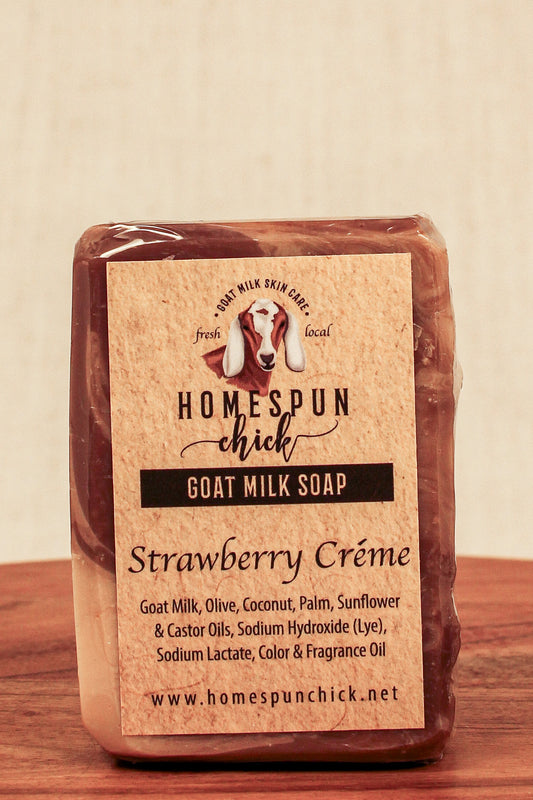 Goat milk soap bar with 'Homespun Chick' label on a wooden surface