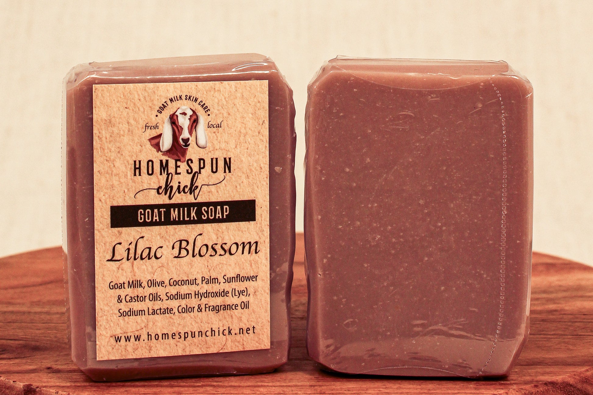 Homespun Chick goat milk soap bar with packaging on a wooden surface