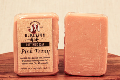 Pink Peony goat milk soap with a label on a wooden surface