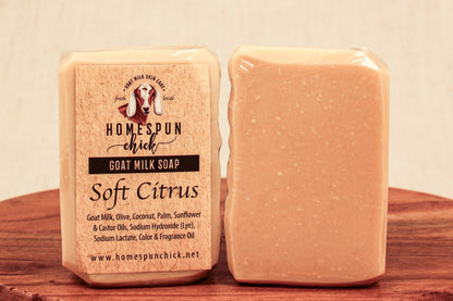 Two bars of soap with a 'Homespun Chick' label on a wooden surface.