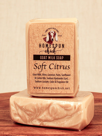 Bar of goat milk soap with 'Homespun Chick' branding on a wooden surface.